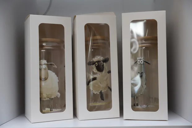 Dekorative Motivflaschen in hellen Geschenkboxen